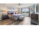 Bedroom boasting a large bed, coordinating furniture, and a bright window at 7554 Oak Spring Ln, Davenport, FL 33837