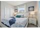 Bedroom featuring a queen bed, soft blue accents, natural light, and closet at 7554 Oak Spring Ln, Davenport, FL 33837