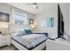 Calm bedroom with a ceiling fan, a plush queen bed, and soft blue accents at 7554 Oak Spring Ln, Davenport, FL 33837