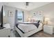 Bedroom with an attractive ceiling fan, stylish decor, and a serene lakeside view at 7554 Oak Spring Ln, Davenport, FL 33837