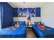 ' bedroom featuring two twin beds with Disney themed decor and a mural at 7554 Oak Spring Ln, Davenport, FL 33837