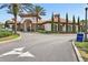 Beautiful clubhouse exterior with a tiled roof, manicured landscaping and welcoming signage at 7554 Oak Spring Ln, Davenport, FL 33837