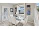Bright dining area with glass table, seating for six, and modern decor with neutral colors at 7554 Oak Spring Ln, Davenport, FL 33837