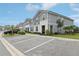 Well-maintained gray townhomes with landscaped lawns and clearly marked parking at 7554 Oak Spring Ln, Davenport, FL 33837