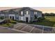 Two-story townhome featuring a gray exterior, solar panels, landscaping, and convenient parking spaces at 7554 Oak Spring Ln, Davenport, FL 33837
