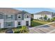 Charming townhouse featuring two stories, a well-manicured lawn, and convenient parking spaces at 7554 Oak Spring Ln, Davenport, FL 33837