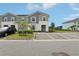 Charming townhome with a well-manicured lawn, mature palm tree and accessible parking at 7554 Oak Spring Ln, Davenport, FL 33837