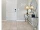 Bright foyer with tile flooring, decorative accents, and convenient smart lock at 7554 Oak Spring Ln, Davenport, FL 33837