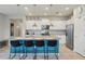 Bright kitchen featuring white cabinets, stainless steel appliances, and island with seating for four at 7554 Oak Spring Ln, Davenport, FL 33837