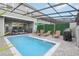 Backyard pool area with lounge chairs and string lights at 7554 Oak Spring Ln, Davenport, FL 33837