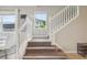 Bright staircase with white railing and wood-look treads leading to the second floor at 7554 Oak Spring Ln, Davenport, FL 33837