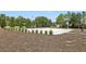 Outdoor sand volleyball court surrounded by mature trees and lush landscaping at 7554 Oak Spring Ln, Davenport, FL 33837