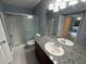 Bathroom features granite countertop vanity, mirror, toilet, and shower at 814 Crest Pines Dr # 915, Orlando, FL 32828