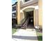 Building entrance with metal stairs leading to upper units and well-maintained landscaping at 814 Crest Pines Dr # 915, Orlando, FL 32828