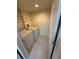 Efficient laundry room features a washer, dryer, tile flooring, and shelving for organized storage solutions at 814 Crest Pines Dr # 915, Orlando, FL 32828