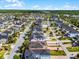 Aerial view of a residential neighborhood with many houses and green trees. The property is outlined in red at 8554 Tallfield Ave, Orlando, FL 32832