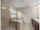 Bathroom featuring a glass-enclosed shower, bathtub, tile flooring and double sink vanity at 8554 Tallfield Ave, Orlando, FL 32832