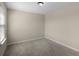 Neutral bedroom with light gray carpeting, a window and base molding at 8554 Tallfield Ave, Orlando, FL 32832