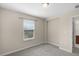 Carpeted bedroom featuring a window and entrance to the main bathroom at 8554 Tallfield Ave, Orlando, FL 32832