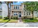 Charming two-story home with lush landscaping and a welcoming brick pathway at 8554 Tallfield Ave, Orlando, FL 32832