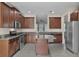Well-equipped kitchen featuring stainless steel appliances and a granite island at 8554 Tallfield Ave, Orlando, FL 32832