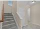 Carpeted staircase leading upstairs with natural light and neutral decor at 8554 Tallfield Ave, Orlando, FL 32832