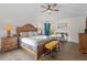 This bedroom features wood laminate flooring, a ceiling fan, and large windows providing natural light at 957 Orange Cosmos Blvd, Davenport, FL 33837