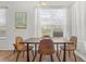 Bright dining room featuring a modern table set, a large window, and a decorative painting at 957 Orange Cosmos Blvd, Davenport, FL 33837