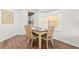 Bright dining area features a light wood table, seating for four, and a sunny window at 957 Orange Cosmos Blvd, Davenport, FL 33837