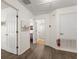 Upstairs hallway with a view to the bedrooms and bathrooms, featuring wood floors and white trim at 957 Orange Cosmos Blvd, Davenport, FL 33837