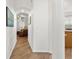 Hallway featuring wood floors, neutral paint, with an arched ceiling and views to other rooms at 957 Orange Cosmos Blvd, Davenport, FL 33837