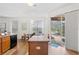 Eat-in kitchen with an island, stainless appliances, and sliding doors to the screened-in patio at 957 Orange Cosmos Blvd, Davenport, FL 33837
