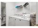 Functional laundry room equipped with modern washer and dryer units and storage shelves at 957 Orange Cosmos Blvd, Davenport, FL 33837
