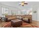 Inviting living room with a plush sectional sofa, ottoman, neutral decor, and plenty of natural light at 957 Orange Cosmos Blvd, Davenport, FL 33837