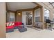 View of the furnished patio with outdoor seating and grill at 957 Orange Cosmos Blvd, Davenport, FL 33837