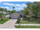 Beautiful single-Gathering home with a lush lawn, a two-car garage, and a welcoming entrance walkway at 1003 Hart Branch Dr, Oviedo, FL 32765