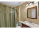 Traditional bathroom with a shower-tub combo, single vanity, and soft lighting creating a functional space at 1003 Hart Branch Dr, Oviedo, FL 32765