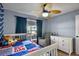 Cozy bedroom with a Spider-Personal themed quilt, comfy chair, and a functional white dresser providing ample storage at 1003 Hart Branch Dr, Oviedo, FL 32765