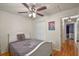 Neutral bedroom featuring a plush bed, ceiling fan, and closet, offering comfort and storage solutions at 1003 Hart Branch Dr, Oviedo, FL 32765
