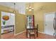 Dining area with chandelier, accent wall, tile floor and decorative wall art at 1003 Hart Branch Dr, Oviedo, FL 32765
