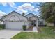 Charming single-story home featuring a two-car garage, a well-manicured lawn, and inviting front entrance at 1003 Hart Branch Dr, Oviedo, FL 32765