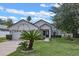 Charming one-story home featuring beautiful landscaping, a two-car garage, and decorative accents at 1003 Hart Branch Dr, Oviedo, FL 32765