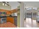 Open concept kitchen with stainless steel appliances flowing into a living area with a pool view at 1003 Hart Branch Dr, Oviedo, FL 32765