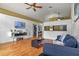 Stylish living room with sleek wood floors and view to other rooms plus modern entertainment center at 1003 Hart Branch Dr, Oviedo, FL 32765
