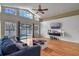 Bright living room with high ceilings, pool view, wood floors, ceiling fan, and contemporary decor at 1003 Hart Branch Dr, Oviedo, FL 32765
