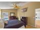 Spacious bedroom featuring a ceiling fan, dresser, and a view to a pool at 1003 Hart Branch Dr, Oviedo, FL 32765