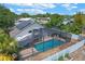 Backyard with screened-in pool area, solar panels and privacy fence at 1003 Hart Branch Dr, Oviedo, FL 32765