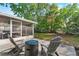 Secluded backyard patio features an outdoor fireplace and comfortable seating, perfect for enjoying nature at 105 Dublin Dr, Lake Mary, FL 32746