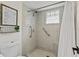 Bathroom shower with tiled walls, glass block window and grab bars for safety at 105 Dublin Dr, Lake Mary, FL 32746