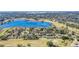 Aerial view showcasing the community with houses, a lake, and lush landscaping at 1136 Villa Ln # 96, Apopka, FL 32712